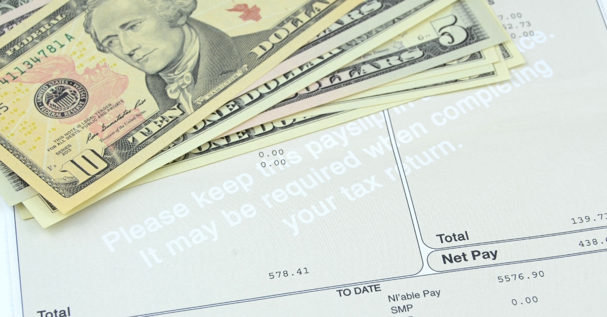 banknotes over payslip