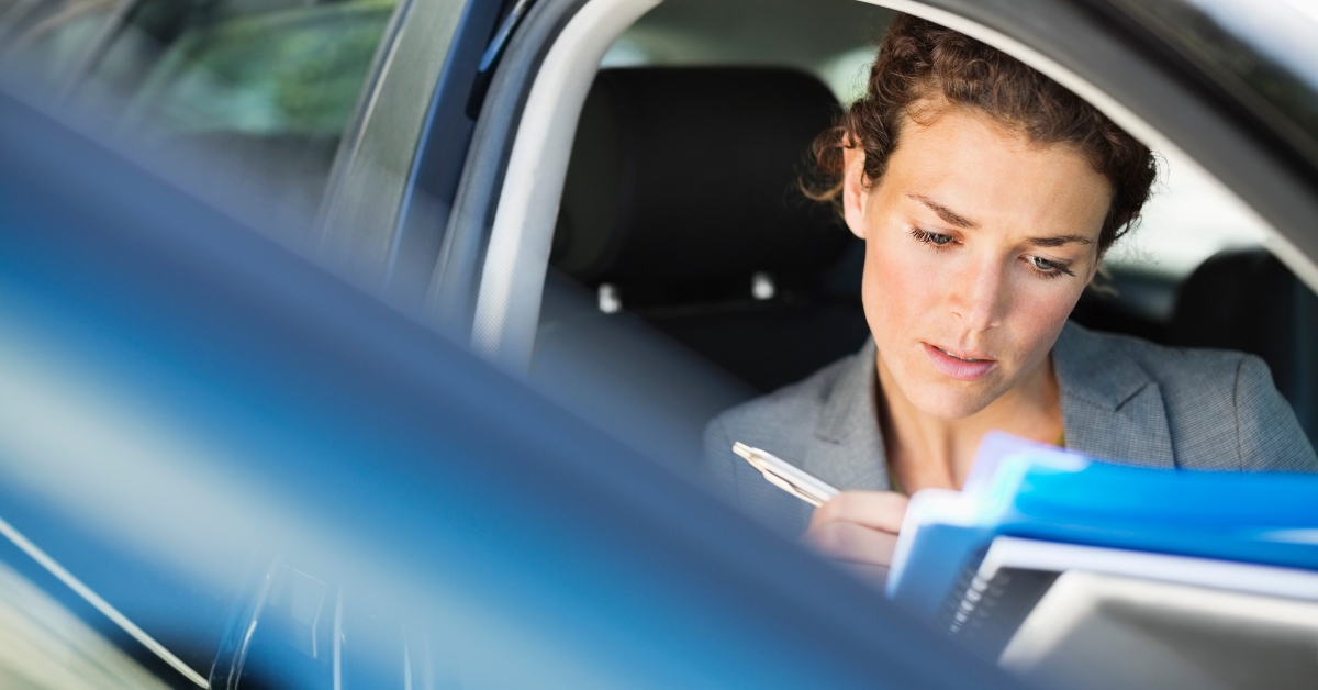 Businesswoman working in car
