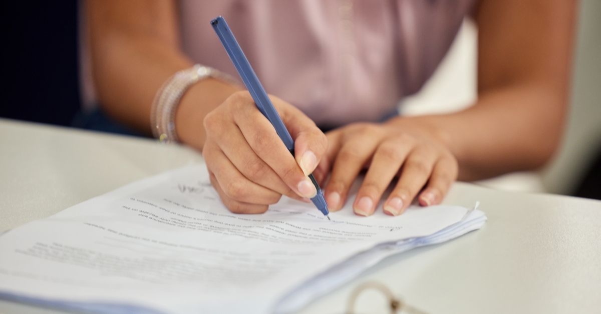 Woman signing insurance agreement