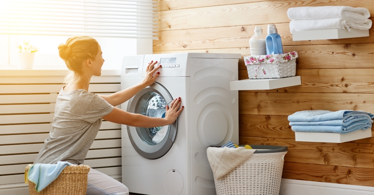 Happy housewife in laundry room