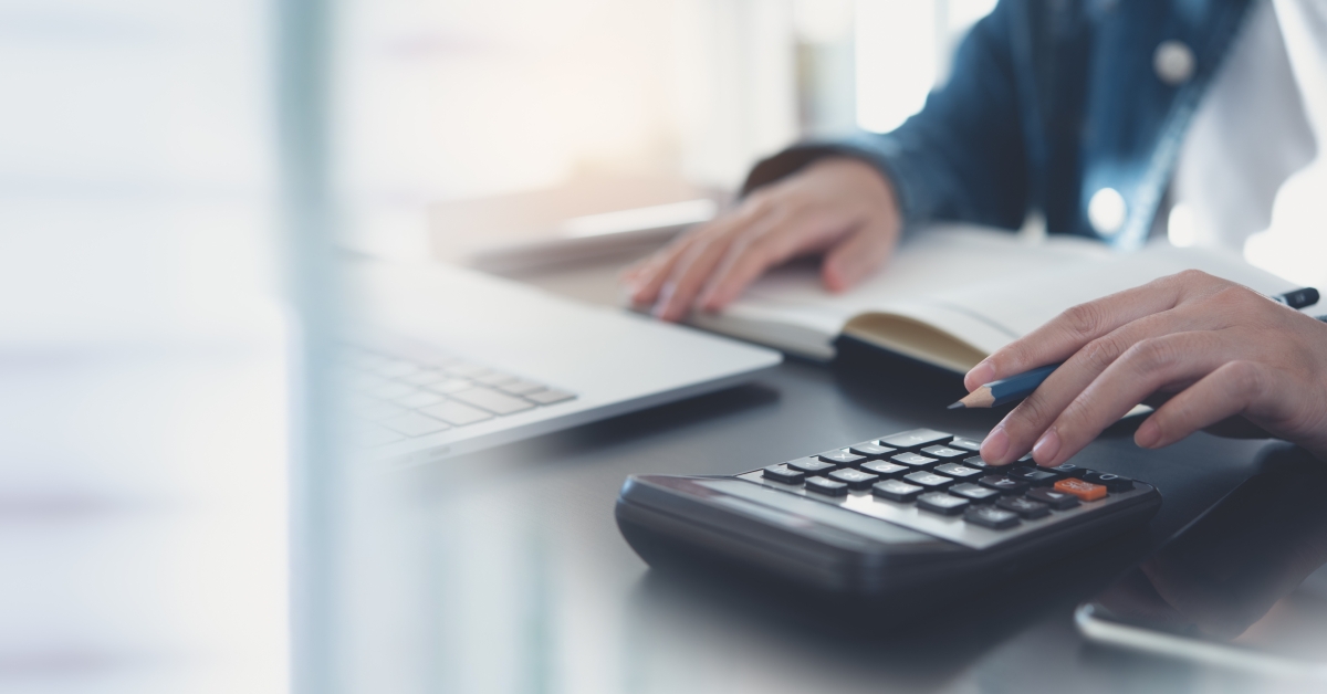 Woman calculating monthly expenses