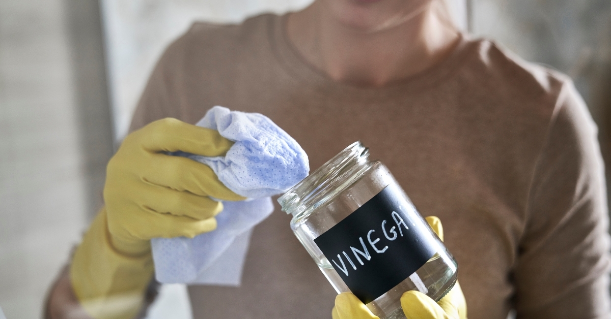 woman cleaning vinegar jar