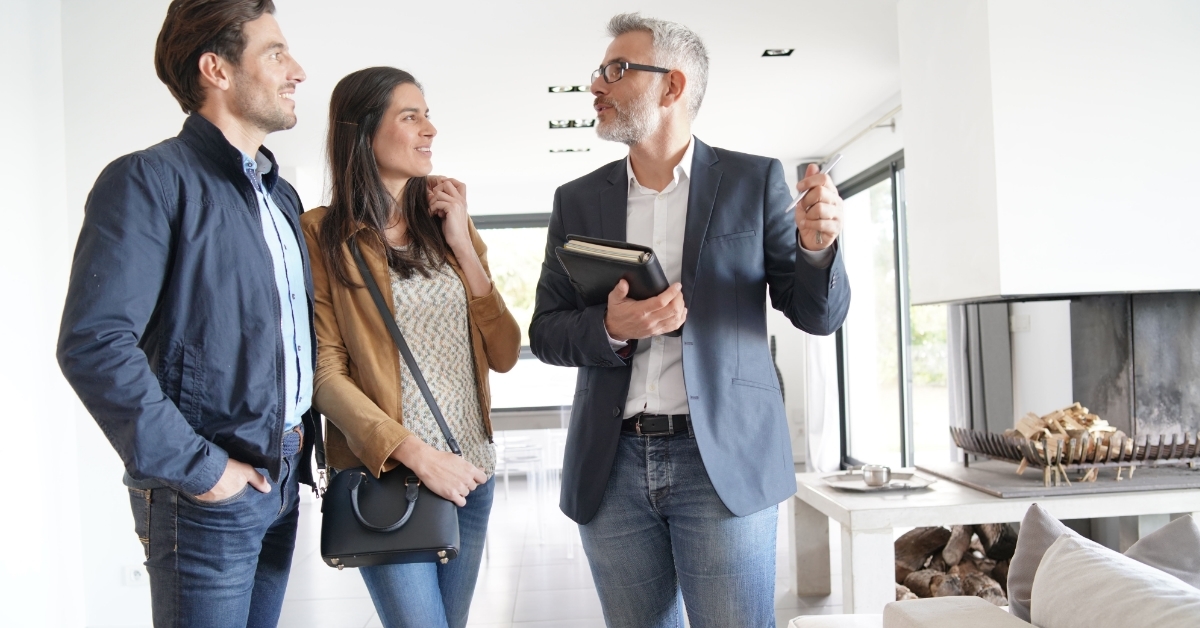 Couple with realtor visiting modern house