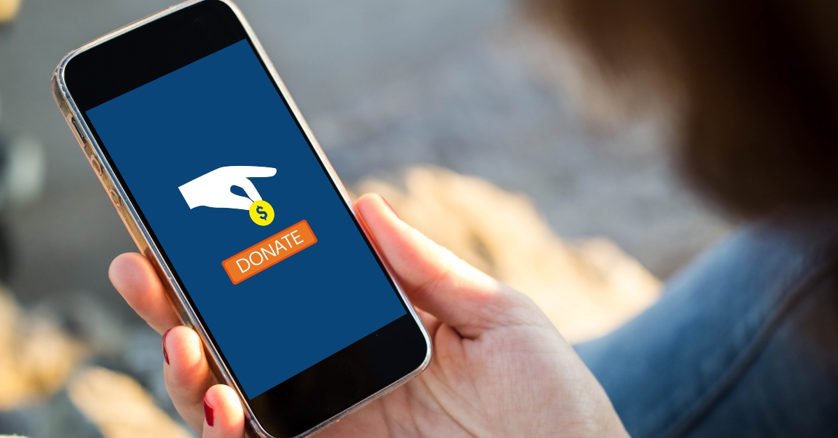 donating money with her smartphone