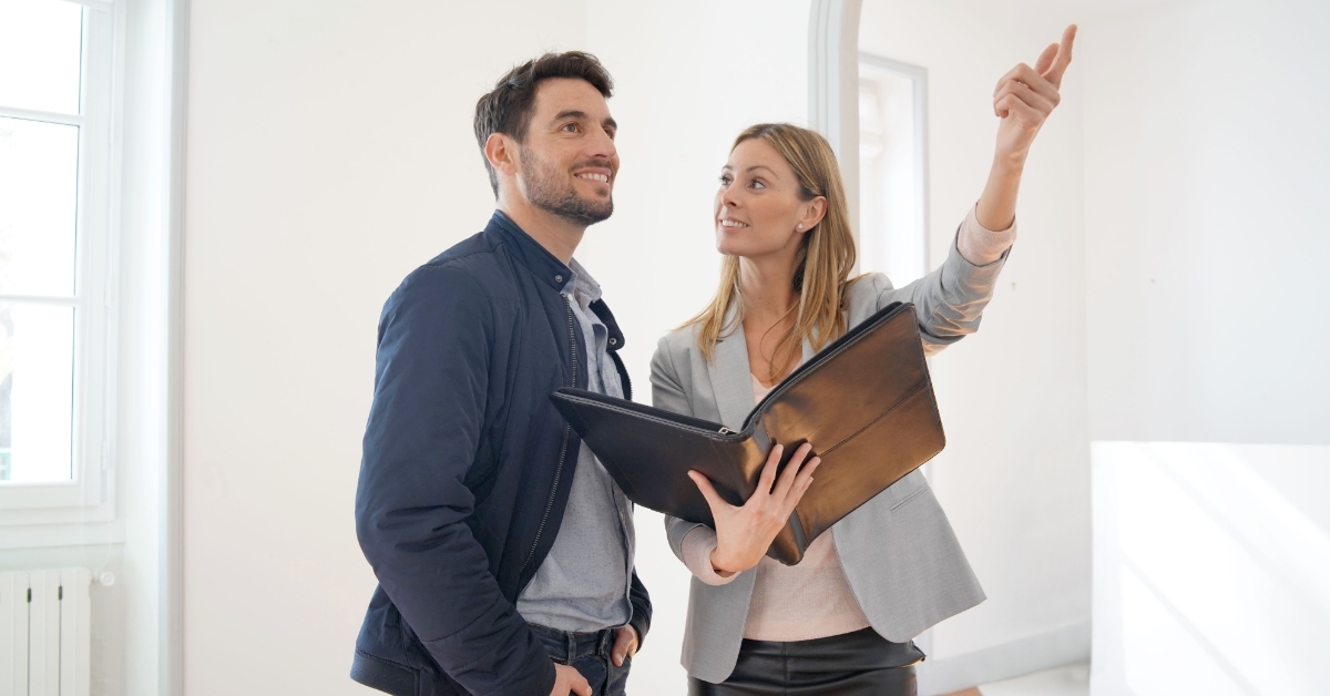 estate agent showing contemporary house to client
