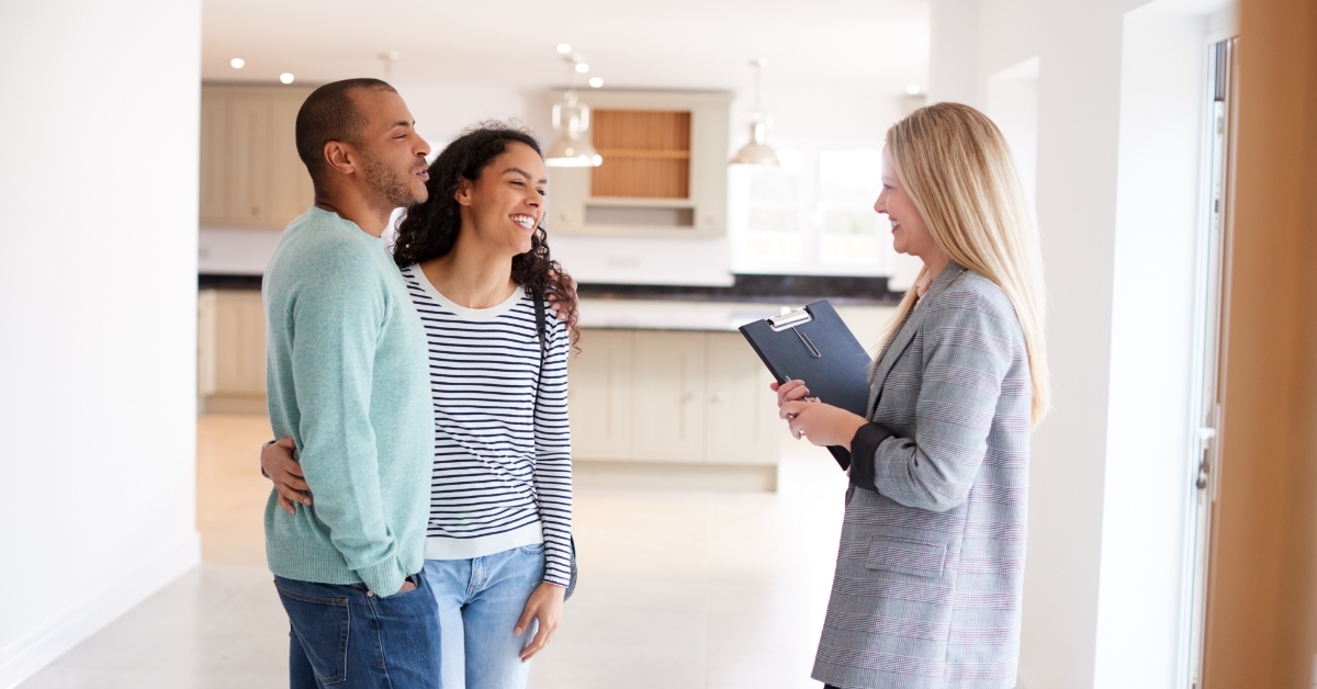 happy Female Realtor Showing Couple new House