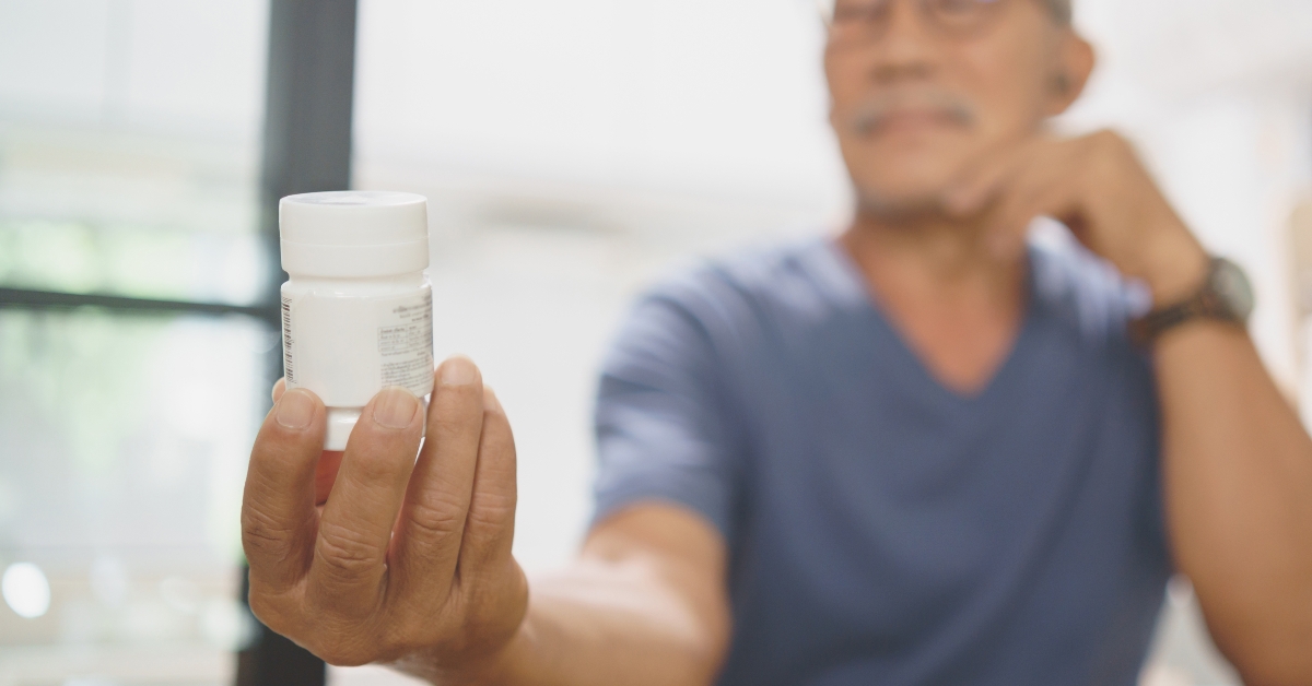 man holding medicine bottle