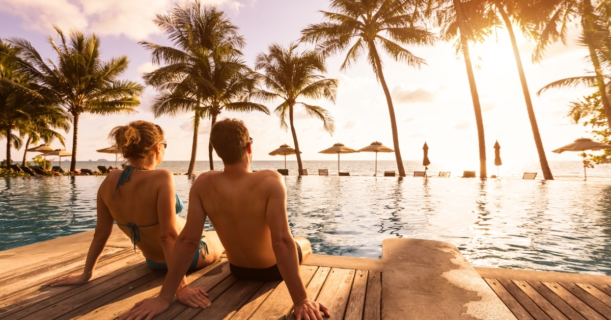 couple enjoying beach vacation at tropical resort 