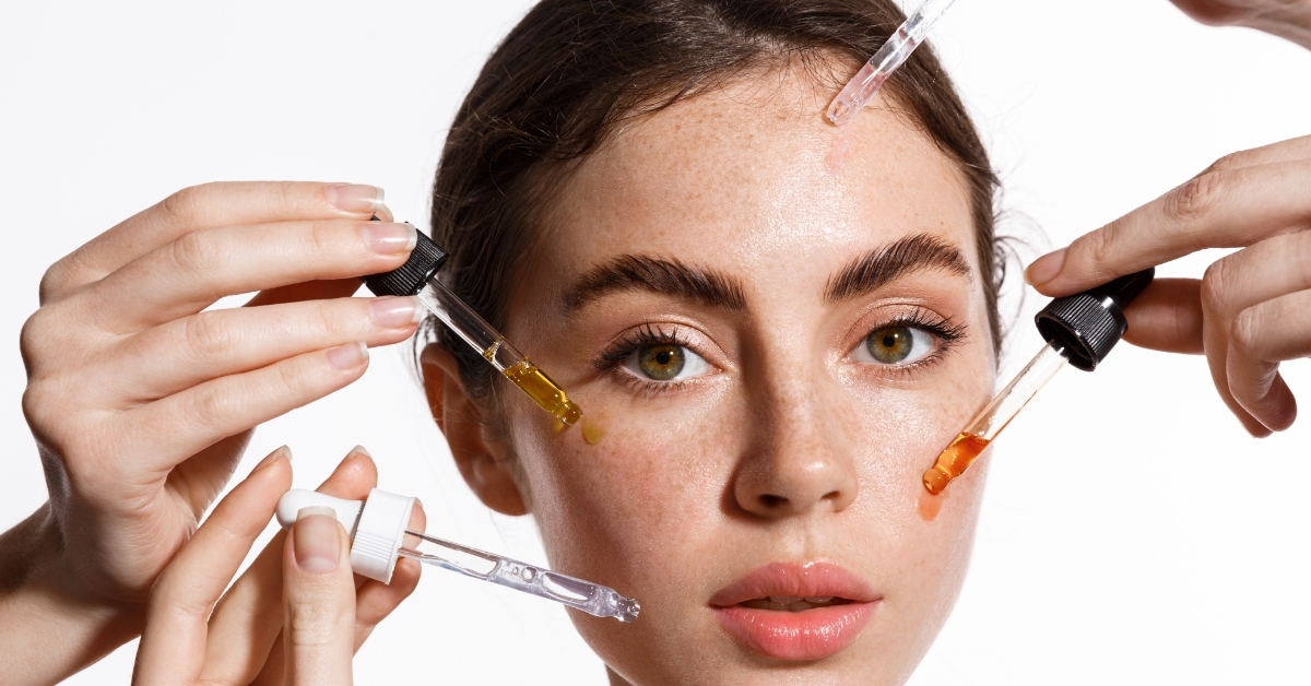 hands applying skincare on woman face