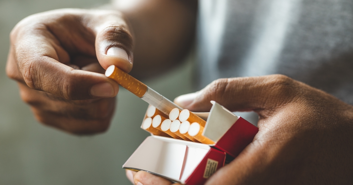 man taking out cigarette from box