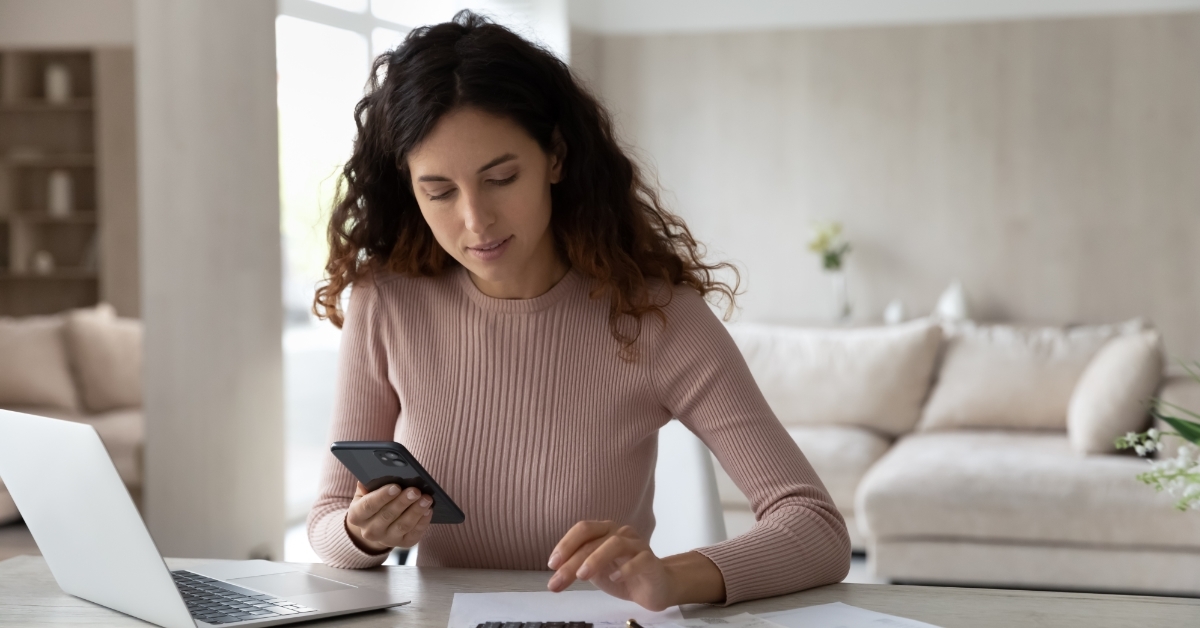 young woman calculatings bills at home
