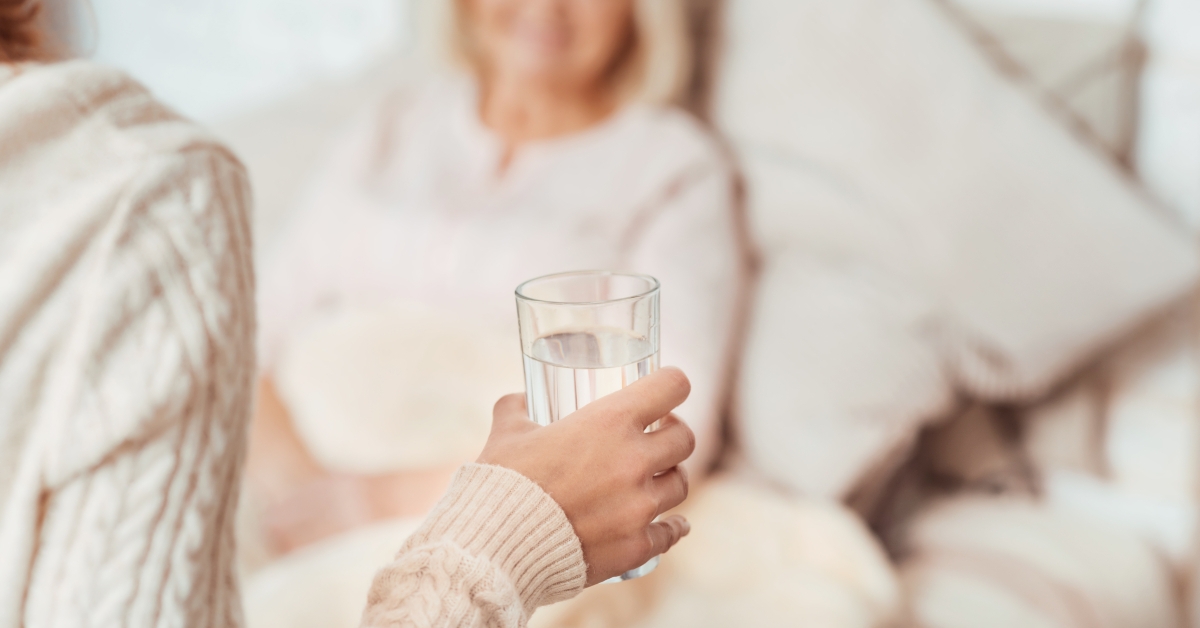 woman holding glass of water