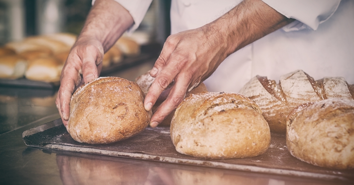 Baker checking freshly baked bread