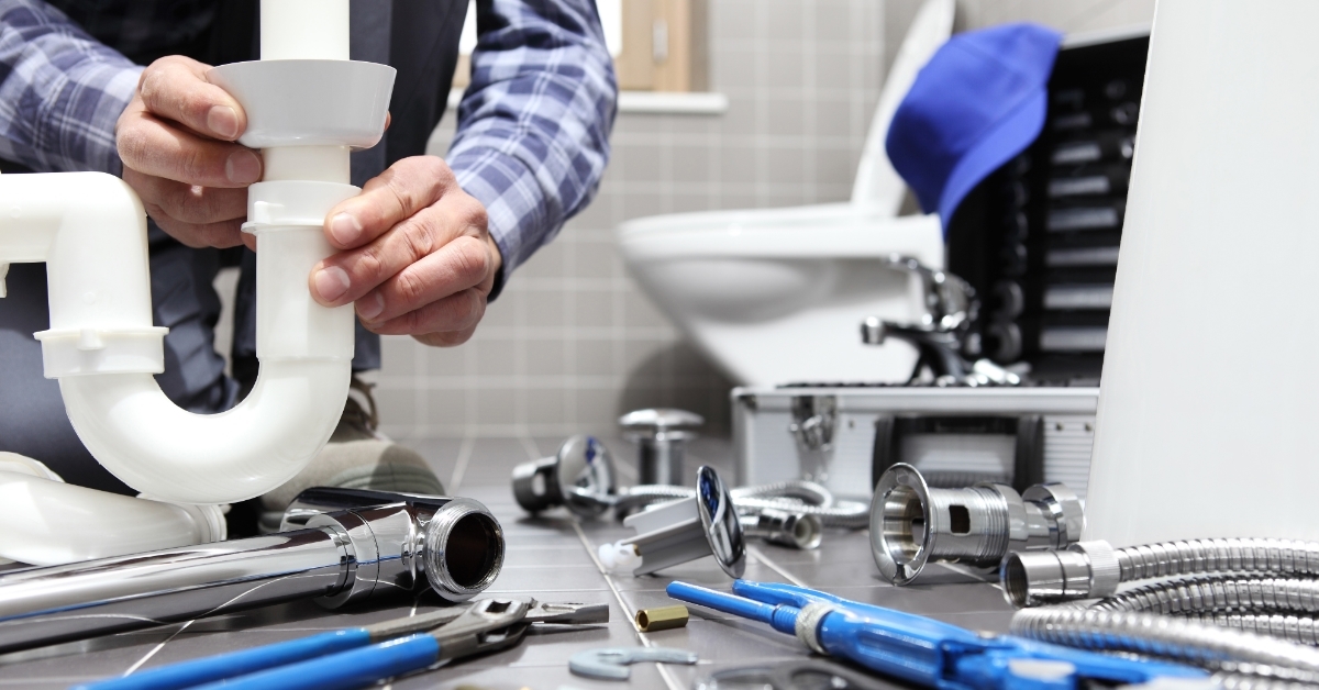 plumber fixing bathroom pipe installation concept