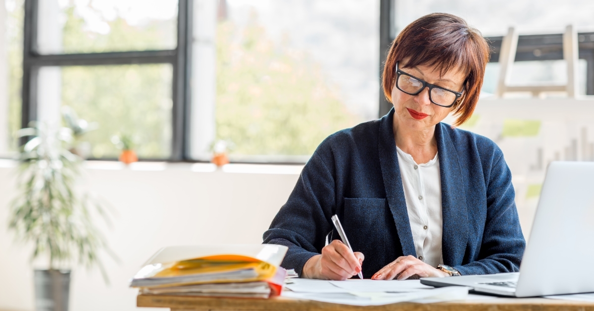 senior business woman checking documents at work