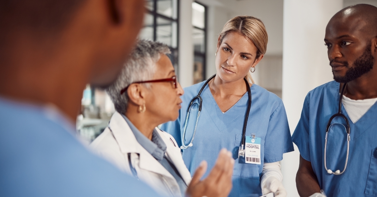 senior doctor talking to nurses at hospital