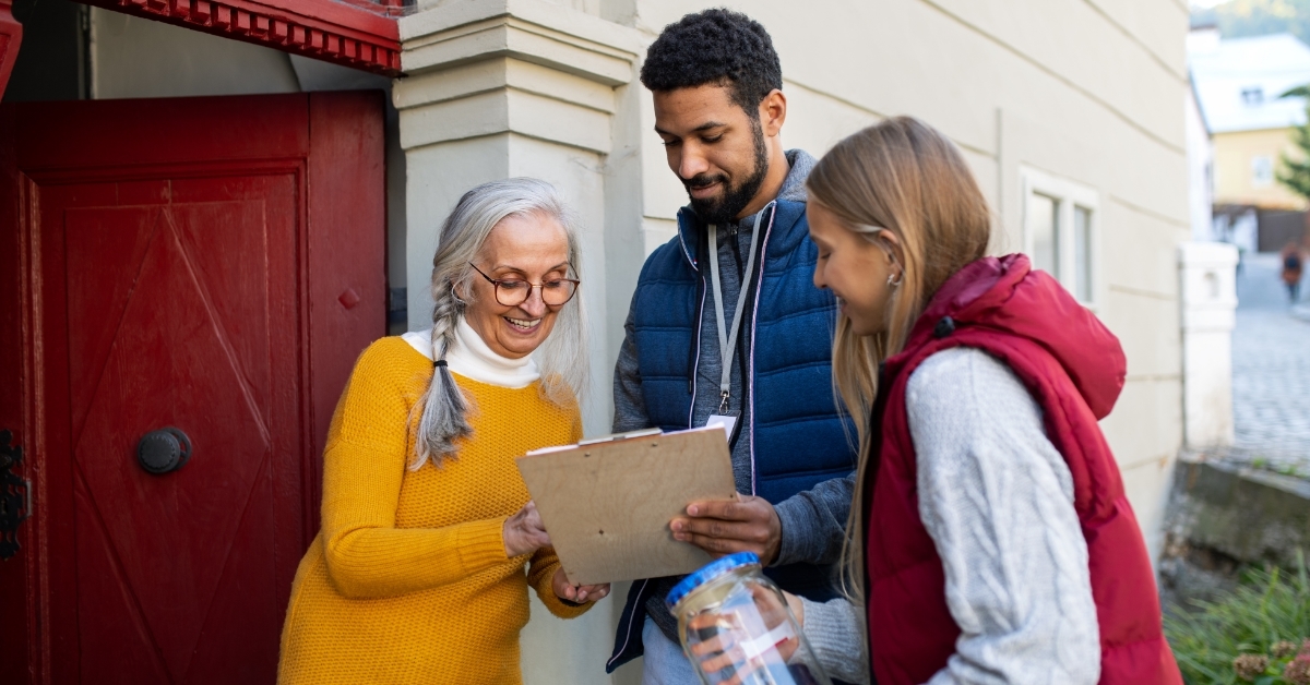 young fundraisers explaining project to senior lady