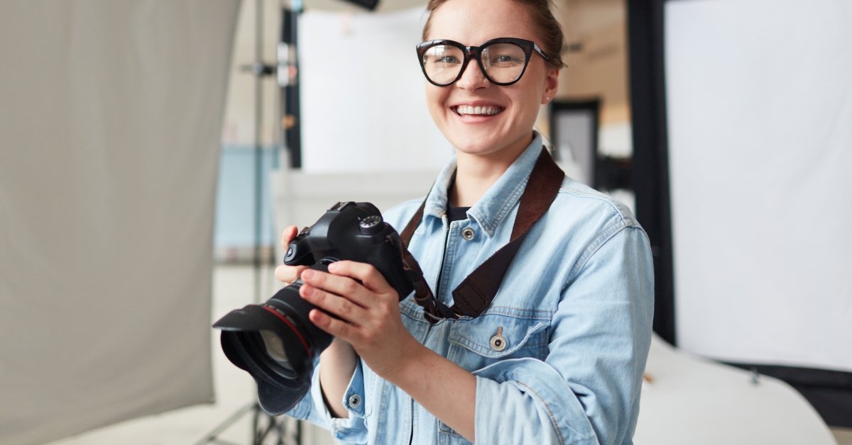 Happy photographer in modern studio