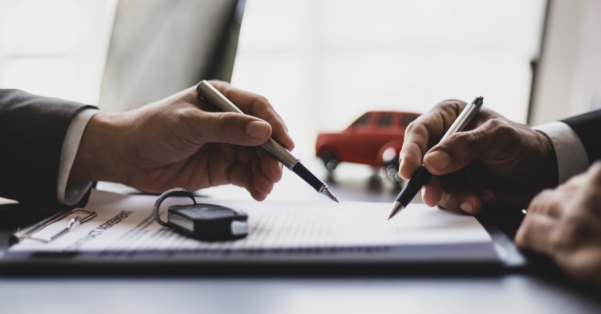 Customer signing car purchase