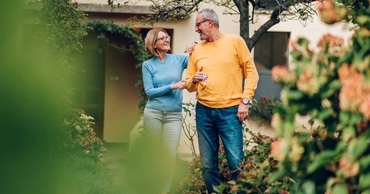 senior couple holding keys