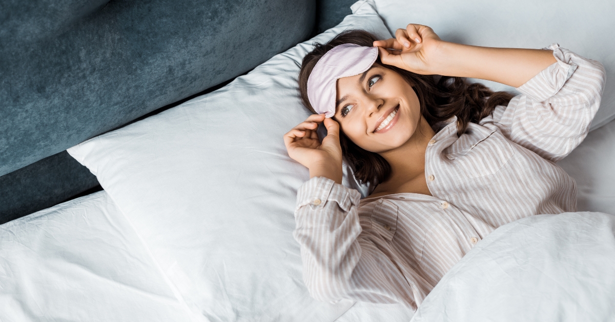 smiling girl in sleeping mask