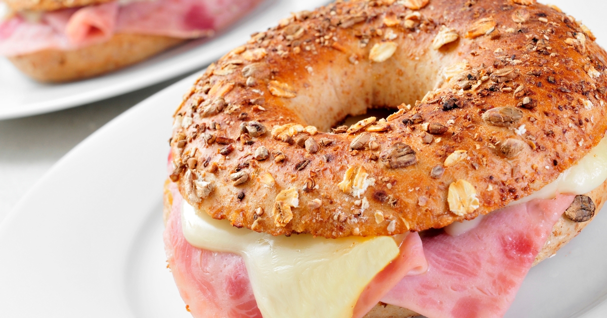 brown bagel filled with ham