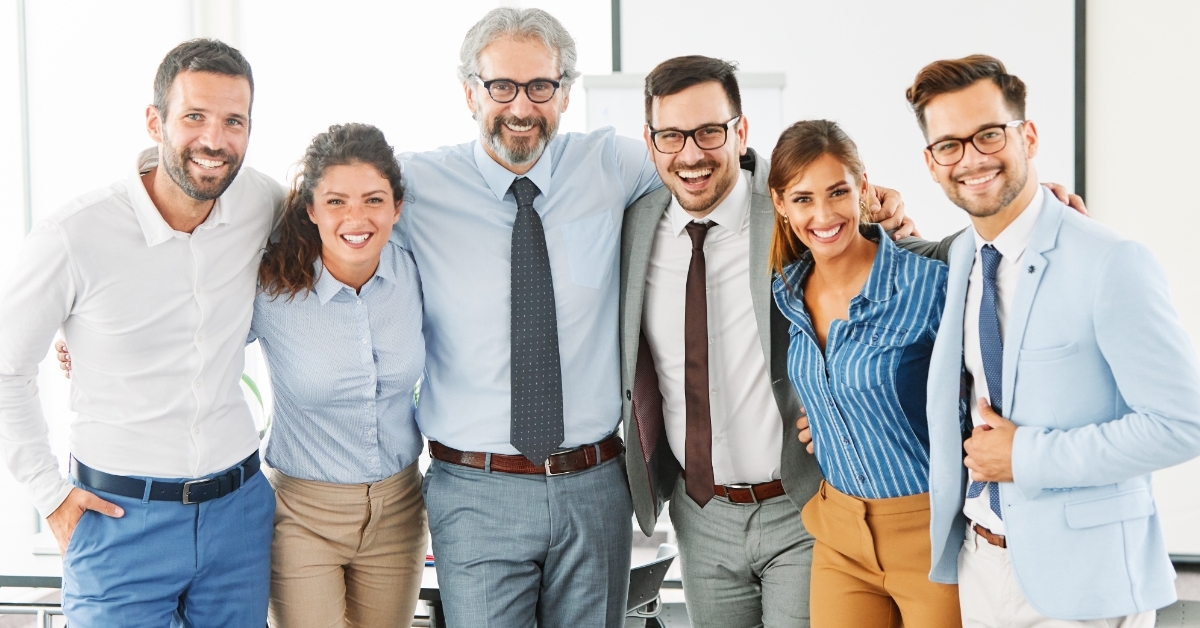 friendly colleagues posing together at work