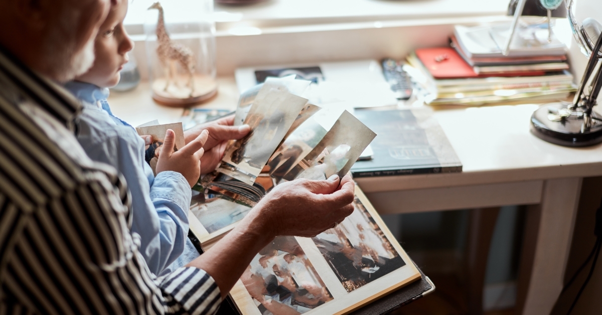 Grandfather and grandson watching family album