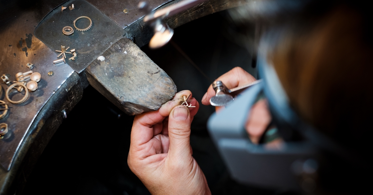 Jeweler saws a gold ring