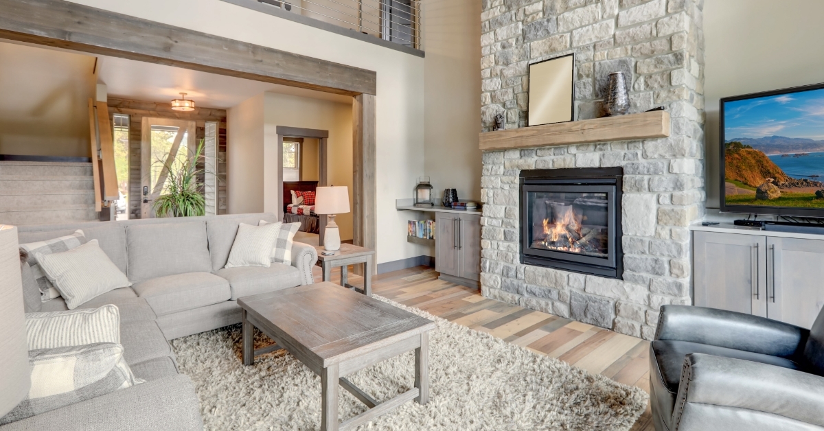 luxury living room with stone fireplace