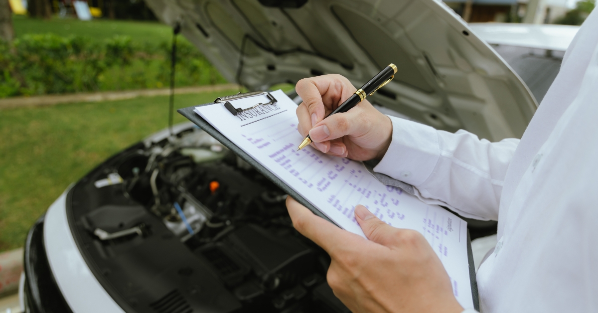 Mechanic inspects a broken-down car