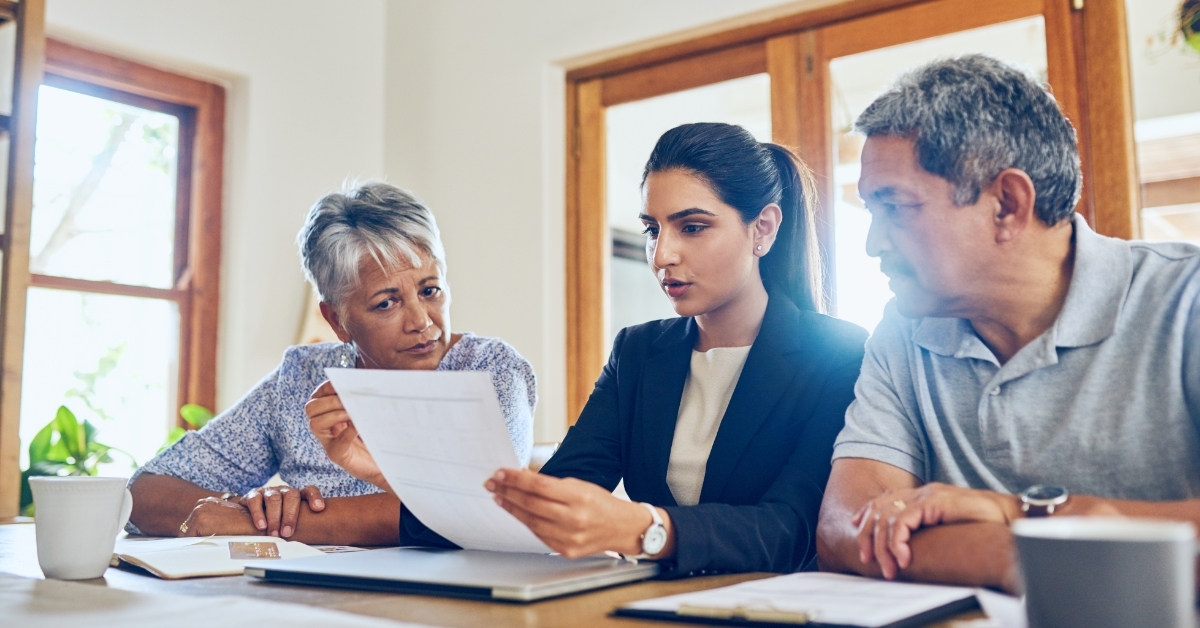 senior couple consulting female finance advisor