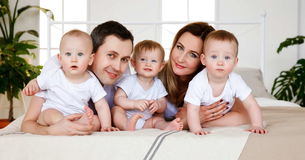 with triplets on the bed