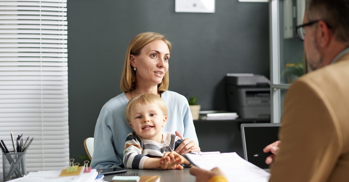 woman with child talking to social worker