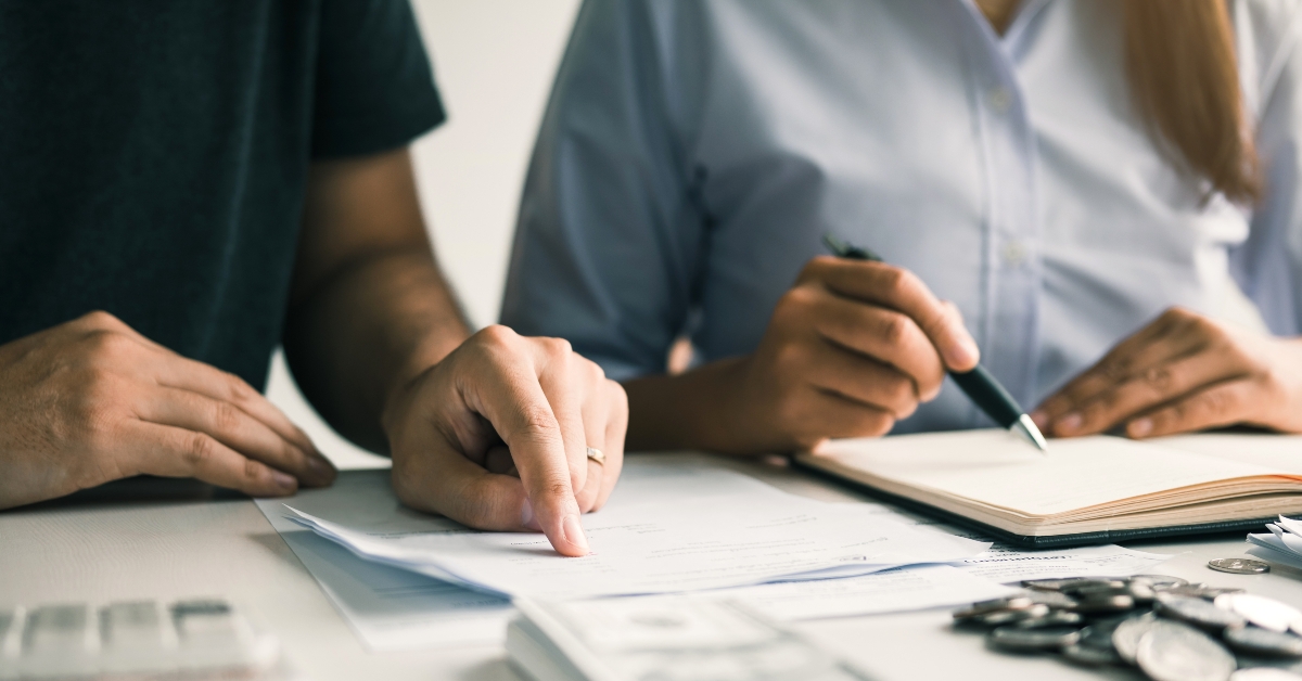 men and women together analyzing expenses 