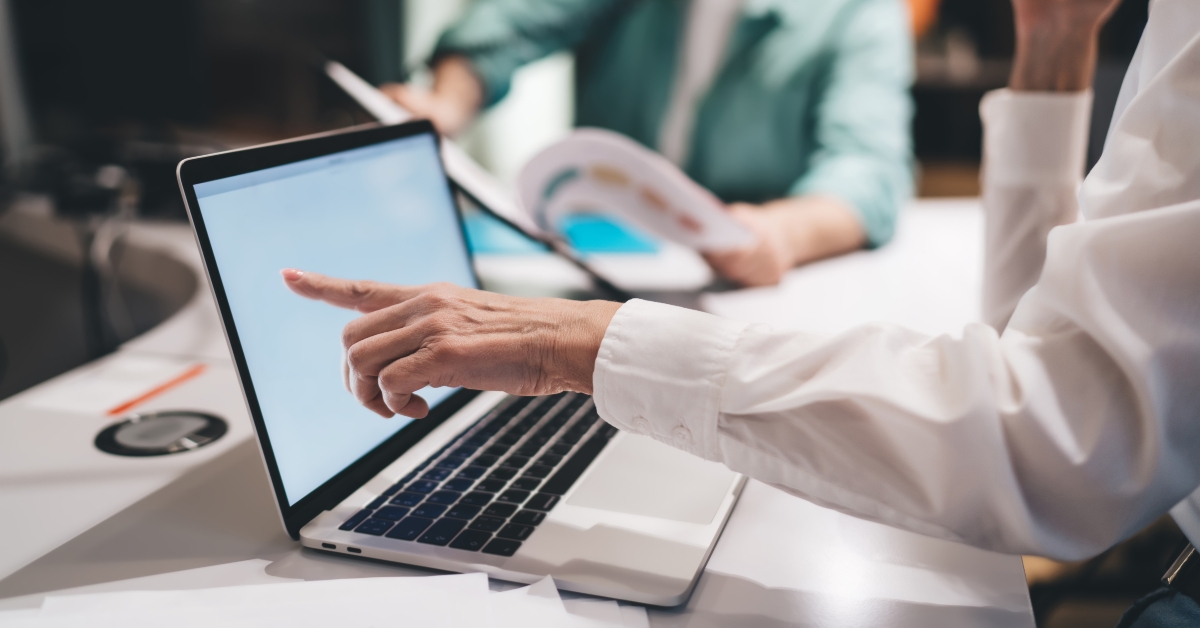 pointing at a laptop screen