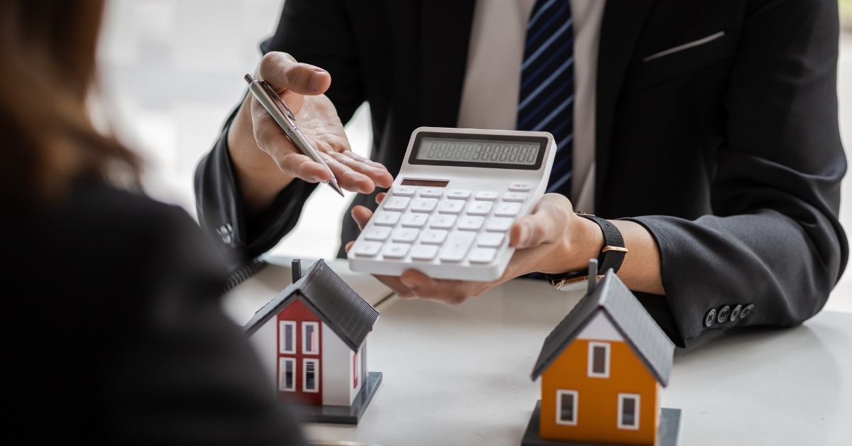 realtor showing quote on calculator to client