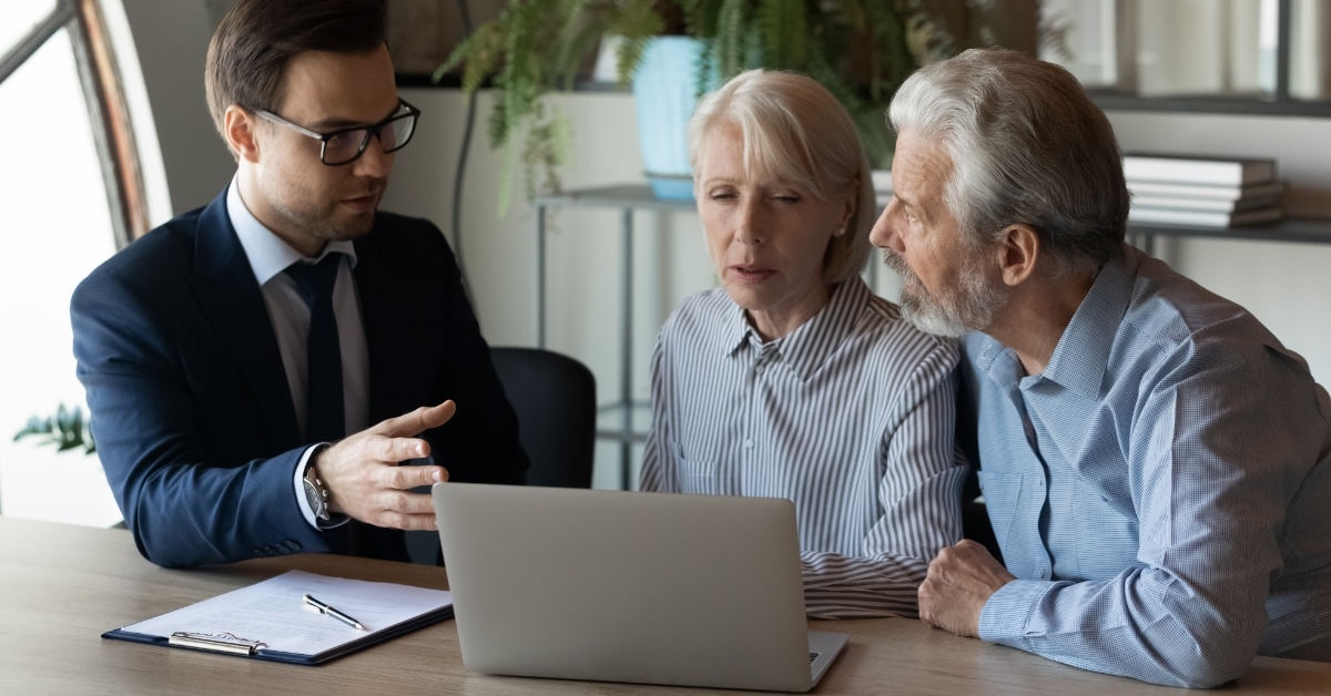 senior couple consulting insurance agent at office