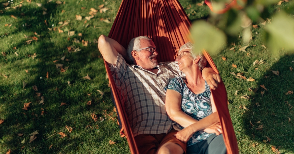 senior couple spending time on hammock outdoors
