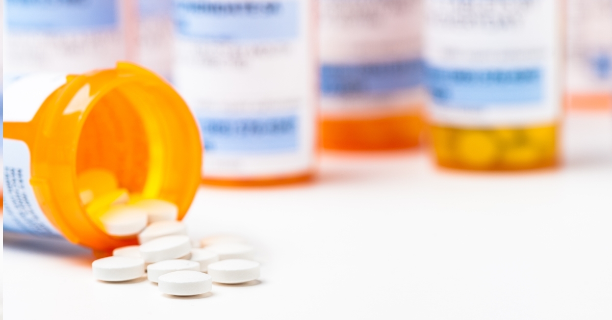 prescription pills over white background