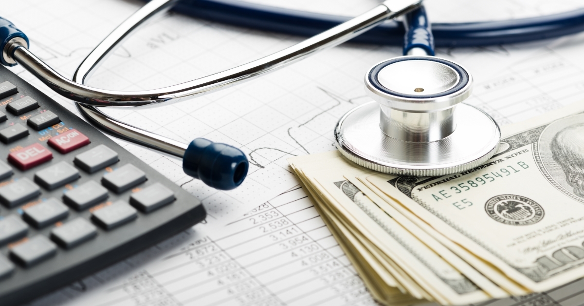 stethoscope over banknotes Health insurance concept