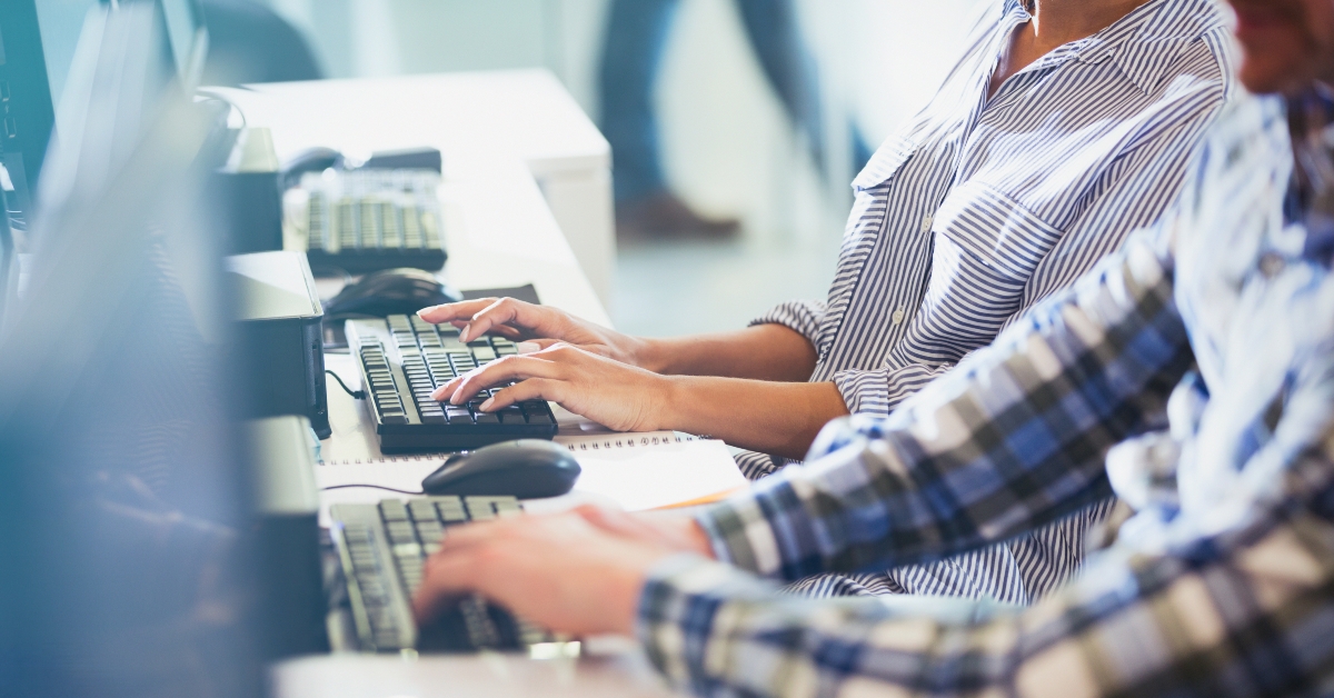 students typing at computers