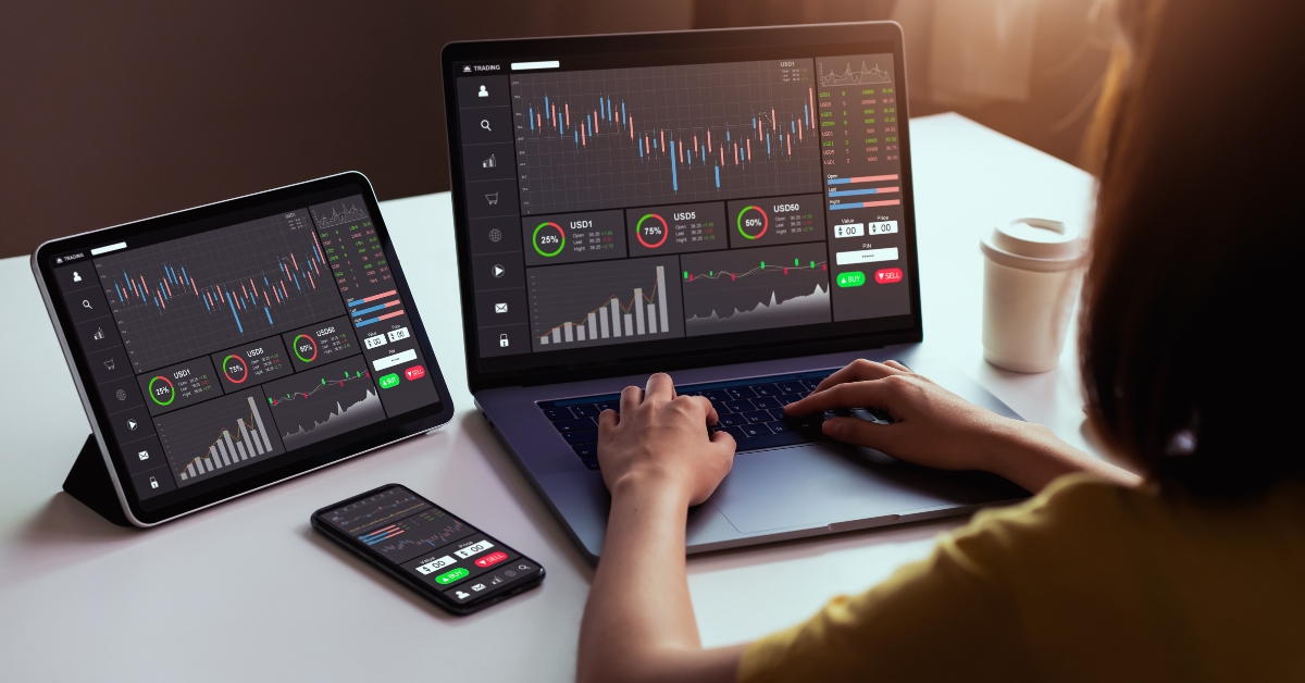 trader looking on laptop