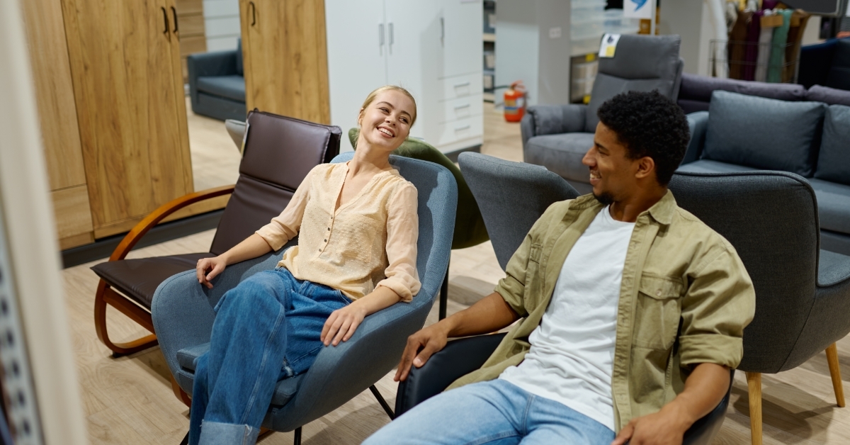 Multiracial couple on chair in furniture store