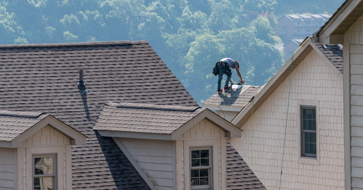 Roofing contractor replacing old shingles