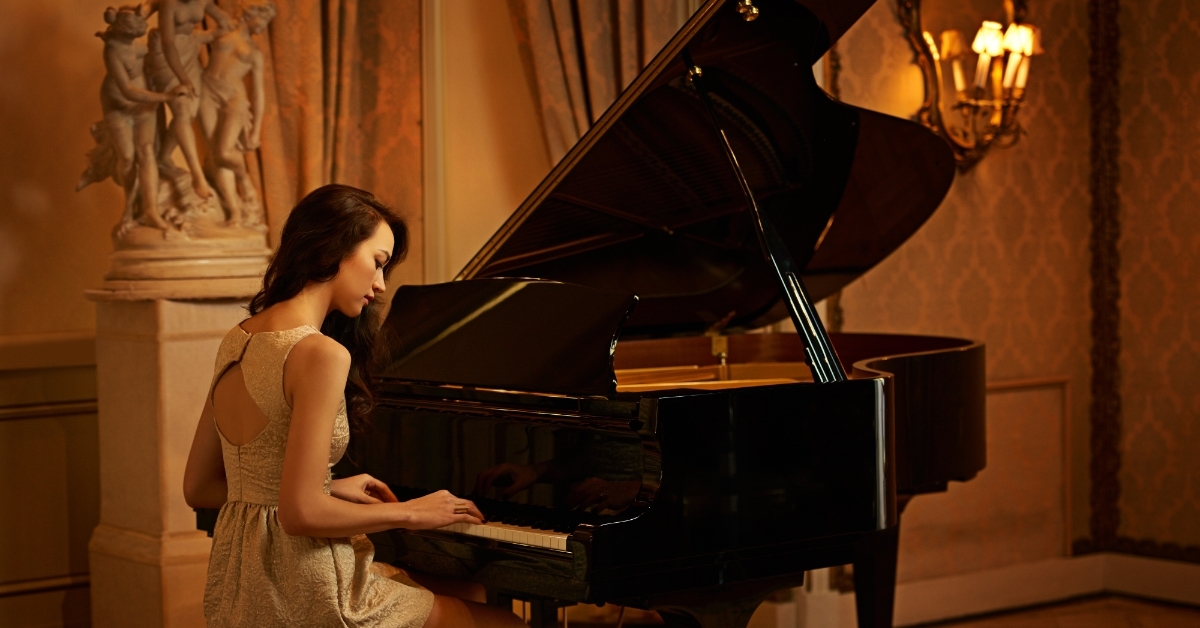 woman playing piano in mansion