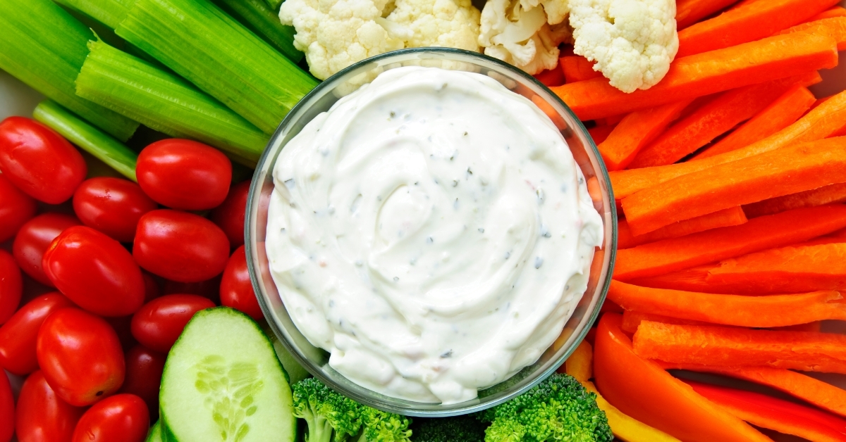 colorful Vegetables arranged around dip bowl
