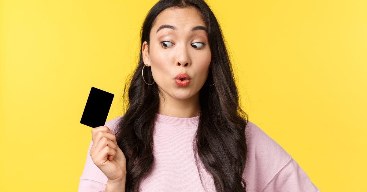 looking amused at credit card