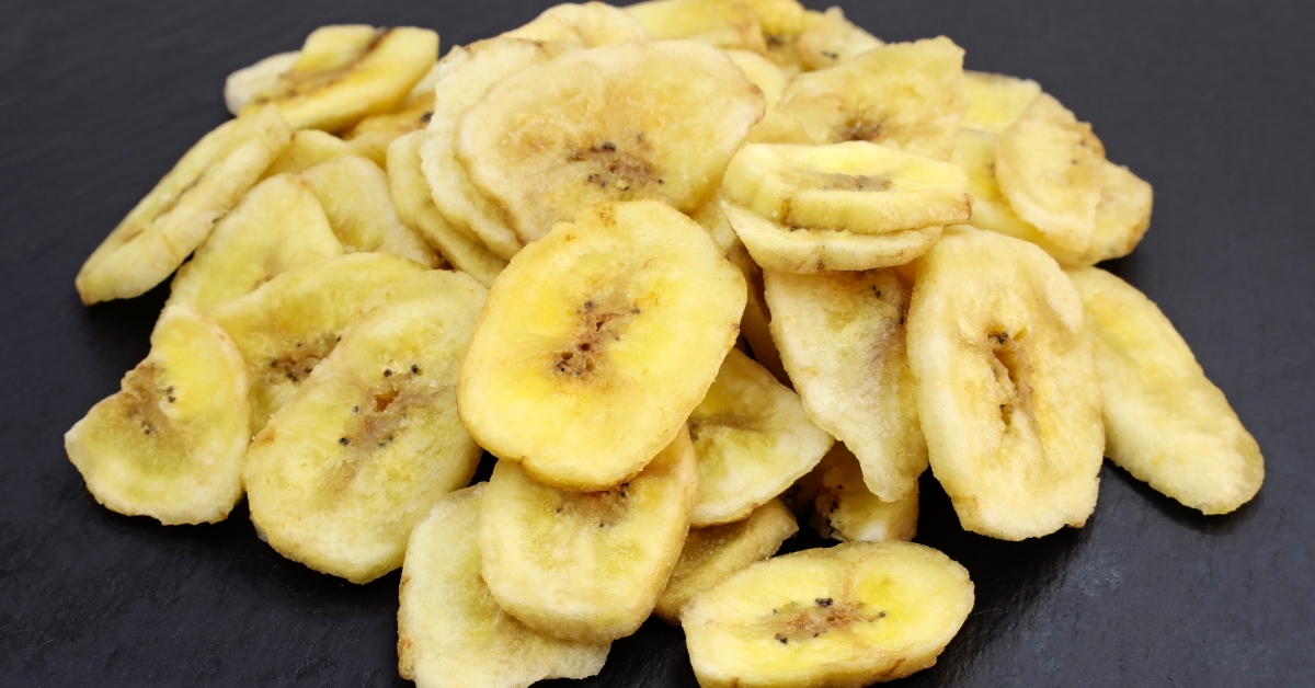 pile dried bananas on black background