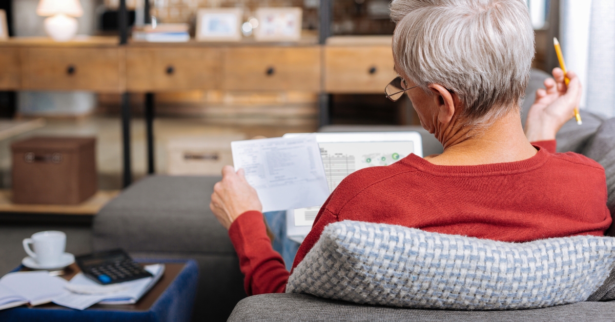 lying on the sofa reading documents